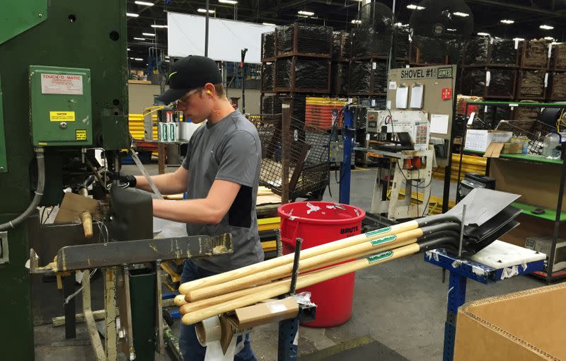 FILE PHOTO: A production line employee works at the AMES Companies shovel manufacturing assembly line in Camp Hill