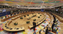 FILE -In this Thursday, Dec. 10, 2020 file photo, European Union leaders stand during a round table meeting at an EU summit in Brussels. As soon as it dawned on the continent more than one year ago that the virus would turn into the worst pandemic in a century, the race for a vaccine was on. In securing one, once it was available, the EU could not be as nimble as such a crisis situation demanded. The EU nations got competitive prices, but it took valuable time. (AP Photo/Olivier Hoslet, Pool, File)