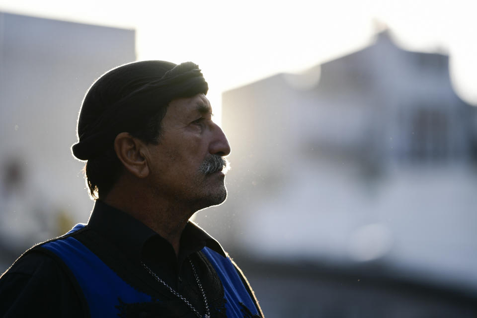 A man dressed in traditional dress from the island of Crete attends a procession ahead of the burial of the late Greek composer, Mikis Theodorakis in Chania Crete island, Greece, Thursday, Sept. 9 2021. Theodorakis died Thursday, Sept. 2, 2021 at 96. He penned a wide range of work, from somber symphonies to popular TV and film scores, including for "Serpico" and "Zorba the Greek." He is also remembered for his opposition to the military junta that ruled Greece from 1967-1974, when he was persecuted and jailed and his music outlawed. (AP Photo/Michael Varaklas)