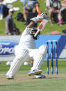 India’s Shikar Dhawan stumbles as he attempts to return to his crease against New Zealand on the second day of the second cricket test in Wellington, New Zealand, Saturday, Feb. 15, 2014.