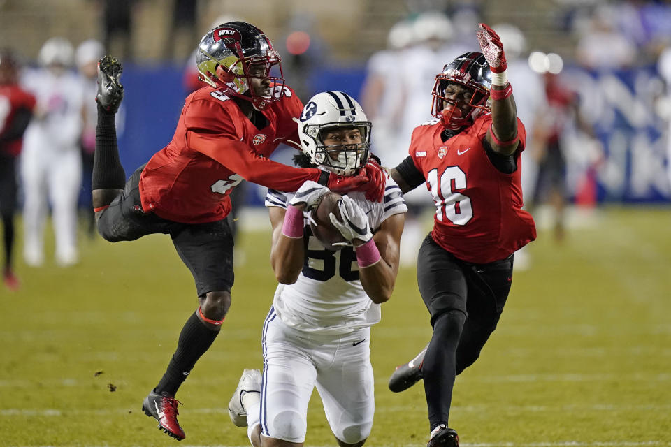 Western Kentucky's Dominique Bradshaw, left, and Kendrick Simpkins (16) defend on an incomplete pass to BYU wide receiver Keanu Hill during the first half of an NCAA college football game Saturday, Oct. 31, 2020, in Provo, Utah. (AP Photo/Rick Bowmer, Pool)