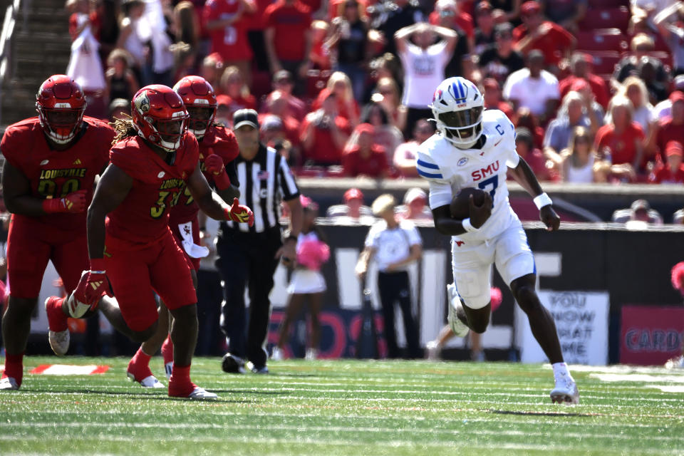 SMU quarterback Kevin Jennings (7) runs from Louisville defense during the first half of an NCAA college football game in Louisville, Ky., Saturday, Oct. 5, 2024. Southern Methodist won 34-27. (AP Photo/Timothy D. Easley)