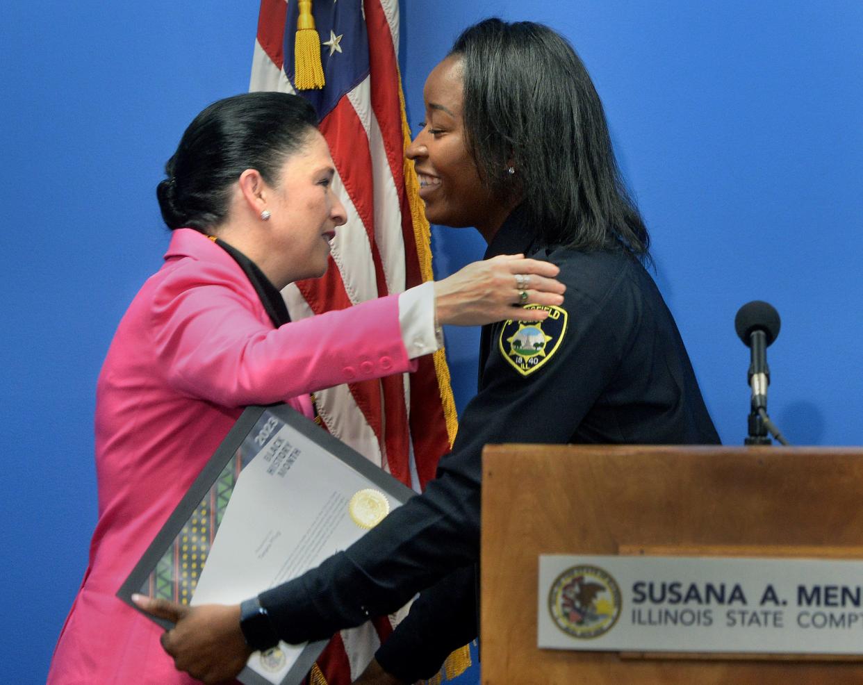 Springfield Police Officer Timara Pflug, right, gets a hug from Illinois State Comptroller Susana Mendoza Thursday Feb. 23, 2023 after Pflug received an award for Celebrate Black History Month in recognition for her work in Springfield.