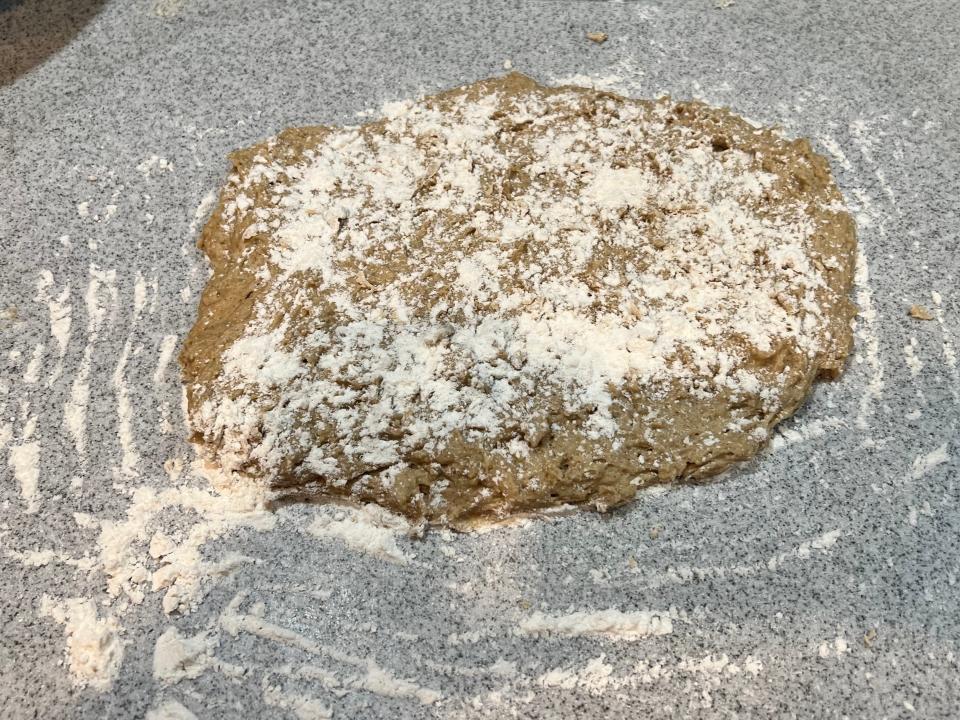 the dough on the cutting board and flour