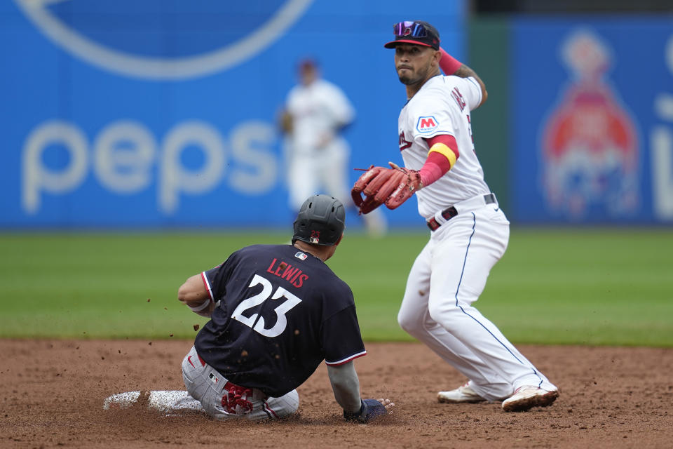 Cleveland Guardians right fielder Gabriel Arias, right, forces out Minnesota Twins' Royce Lewis (23) at second base on a ground ball hit by Minnesota Twins' Max Kepler, who was safe at first base, in the sixth inning of a baseball game Wednesday, Sept. 6, 2023, in Cleveland. (AP Photo/Sue Ogrocki)