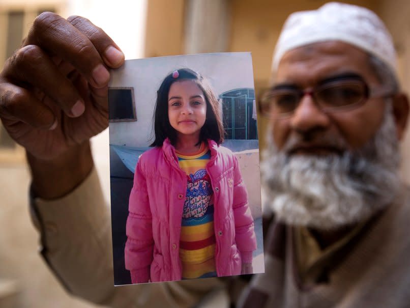 Mohammed Amin shows a picture of his seven year-old daughter, Zainab Ansari whose body was left in a rubbish dump earlier this month: AP