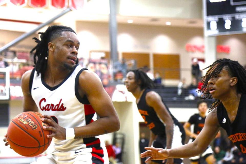 George Rogers Clark’s Reshaun Hampton operates against Frederick Douglass guard Dakari Talbert during the Cardinals’ 56-50 win over the Broncos. Hampton, GRC’s leading scorer this season, finished with 12 on Tuesday night.