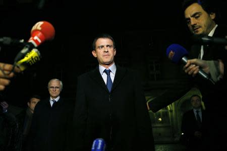 French Interior Minister Manuel Valls (C) attends a news conference at the headquarters of the Paris police November 21, 2013. REUTERS/Gonzalo Fuentes