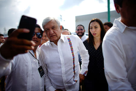 Mexico's new President Andres Manuel Lopez Obrador poses for photos with supporters as he arrives for an event to unveil his plan for oil refining, in Paraiso, Tabasco state, Mexico, December 9, 2018. Picture taken December 9, 2018. REUTERS/Alexandre Meneghini