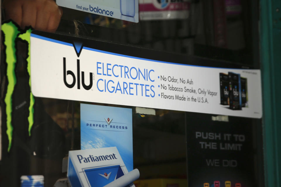 An advertisement for the e-cigarette brand blu is seen on the window of a store in New York May 27, 2014. Some of the leading U.S. producers of electronic cigarettes are moving their manufacturing to the United States from China in response to growing concern about quality and the prospect of tighter federal regulations. Lorillard Inc's blu brand is assembled in China but the liquid is produced in the United States. Reuters reported earlier this week that Reynolds was in active discussions to buy Lorillard. Blu is the top selling e-cigarette brand in the country, with about half of the market share. REUTERS/Shannon Stapleton(UNITED STATES - Tags: SOCIETY BUSINESS)