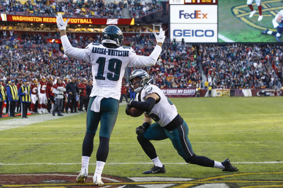 Philadelphia Eagles tight end Zach Ertz (86) is greeted in the end zone by teammate wide receiver J.J. Arcega-Whiteside (19) after scoring a touchdown in the second half of an NFL football game, Sunday, Dec. 15, 2019, in Landover, Md. (AP Photo/Patrick Semansky)