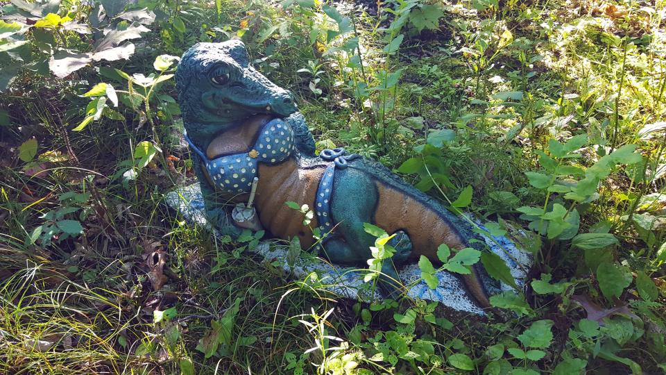 A sunbathing alligator statue sits along the Table Bluff segment of the Ice Age Trail near Cross Plains.