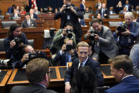 Facebook Chief Executive Officer Mark Zuckerberg, center, is surrounded by photographers after arriving for a hearing before the House Financial Services Committee on Capitol Hill in Washington, Wednesday, Oct. 23, 2019, to discuss his plans for the new cryptocurrency Libra. (AP Photo/Susan Walsh)