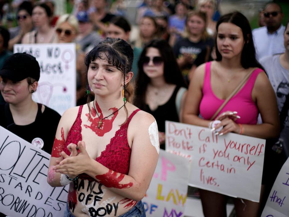 Abortion-rights advocates gather outside a the Kansas Statehouse to protest the Supreme Court's ruling on abortion Friday, June 24, 2022, in Topeka, Kan