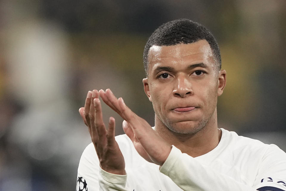 PSG's Kylian Mbappe applauds after the Champions League Group F soccer match between Borussia Dortmund and Paris Saint-Germain at the Signal Iduna Park in Dortmund, Germany, Wednesday, Dec. 13, 2023. (AP Photo/Martin Meissner)