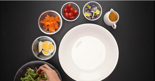 Assemble the salad, eggs, carrots, cherry tomatoes and edible flowers