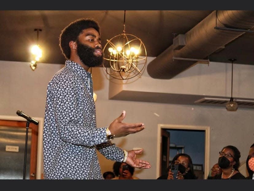 Poetic Zae of Fayetteville performs at an open mic event.