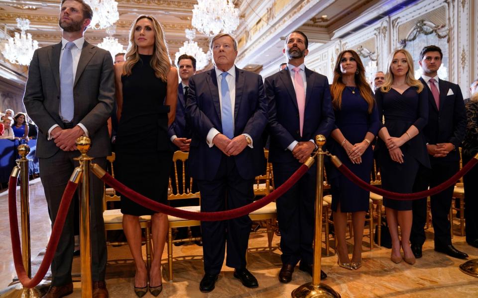 Members of the family listen as former President Donald Trump speaks at his Mar-a-Lago estate - Evan Vucci/AP