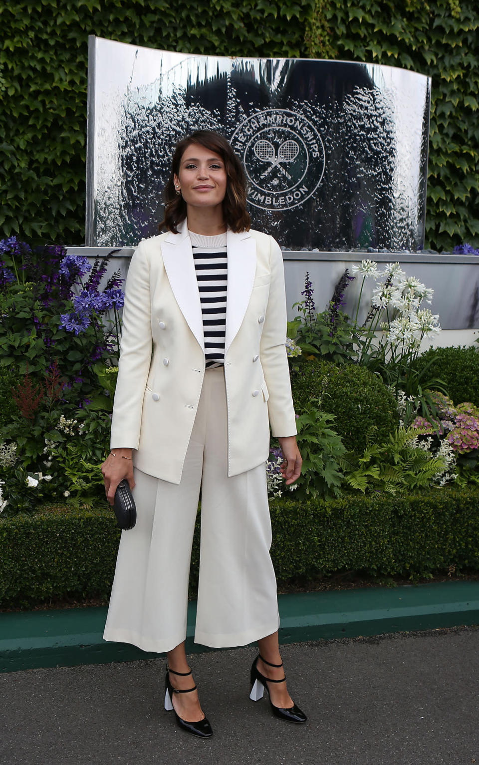 <p>The British actress cut a fashionable figure at Wimbledon, despite the rain. The star donned a very on trend pair of wide-legged culottes, teamed with a striped top and a double breasted blazer. <i>[Photo: PA Images] </i></p>