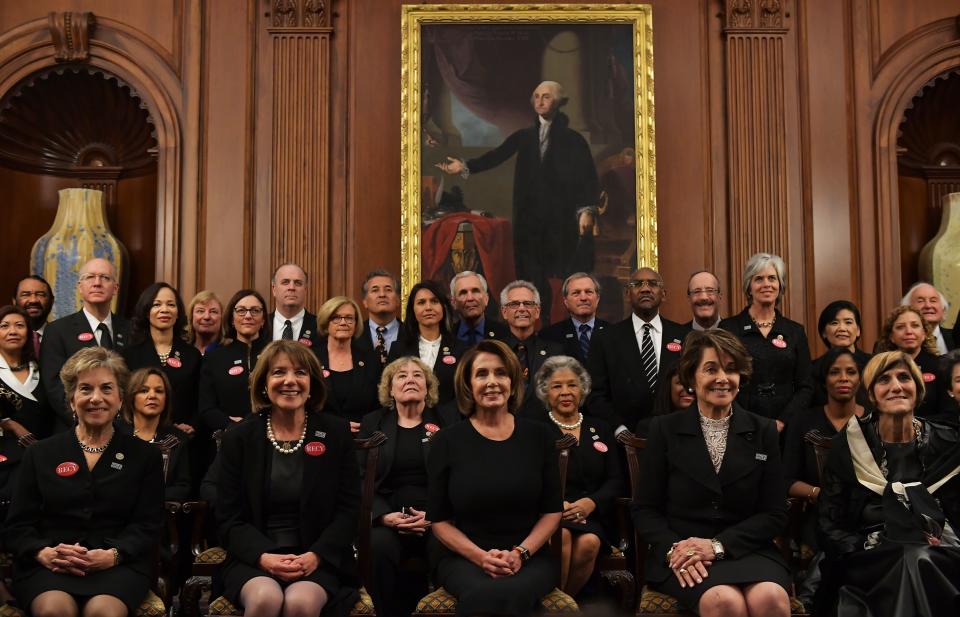 House Minority Leader Nancy Pelosi (D-Calif.), center, poses with members of Congress wearing black in support of the "Me Too" movement.