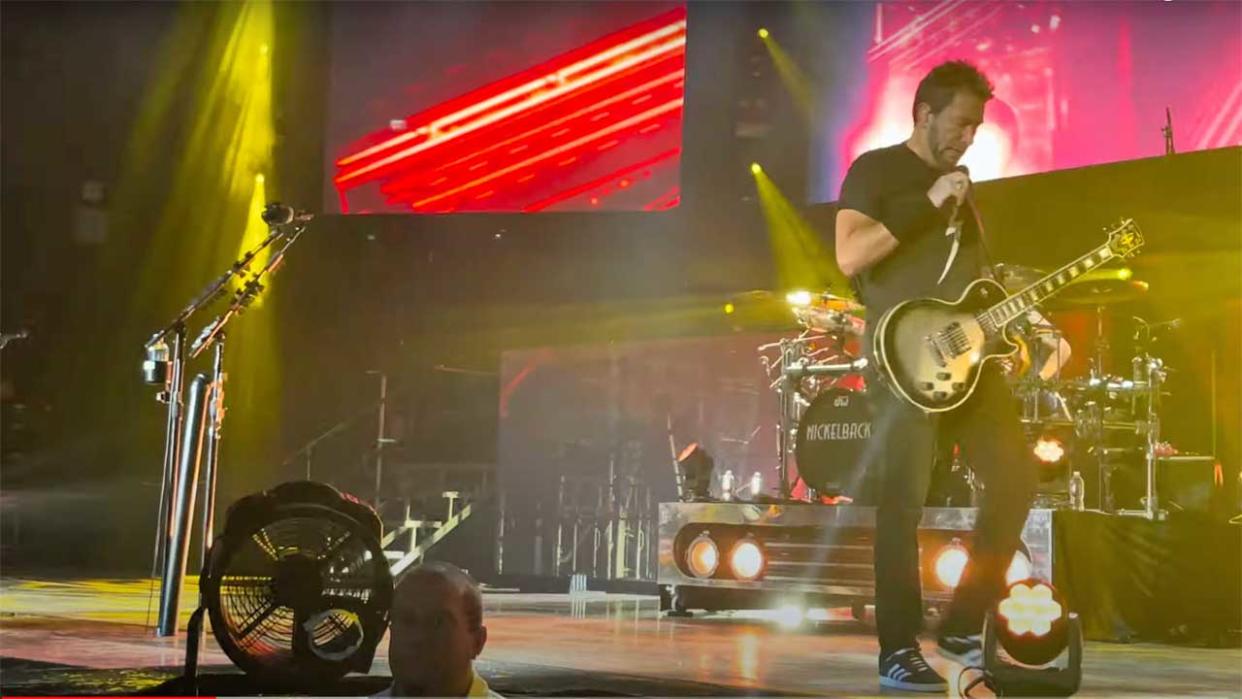  Chad Kroeger looking forlorn onstage 