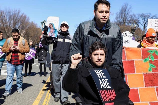 Nate Smith wheels Barkan during a progressive demonstration in Washington. Smith, a high school friend of Barkan's, recalled Barkan's stubborn commitment to justice.