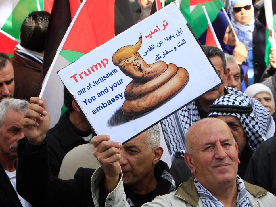 Palestinian demonstrators take part in a protest against a promise by Donald Trump to re-locate the US embassy to Jerusalem, in the West Bank city of Nablus on 19 January Reuters