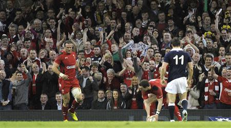 Wales' George North touches down for a try with team mate Jamie Roberts (L) during their Six Nations Championship rugby union match against Scotland at the Millennium Stadium, Cardiff, Wales, March 15, 2014. REUTERS/Rebecca Naden