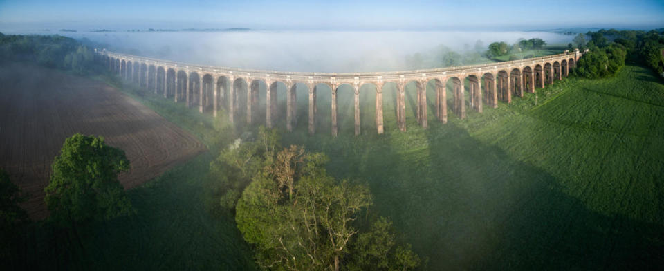 <p>Puffs of cloud hover over the Balcombe viaduct, the route from London to Brighton. </p>