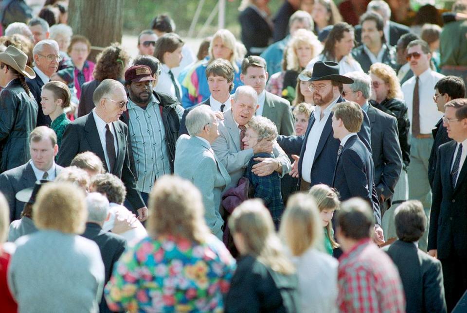 February 22, 1993: Wrestler Kerry Von Erich’s funeral held at First Baptist Church in Dallas. His father, Jack Adkisson, is consoled as he leaves the graveside ceremony at Grove Hill Cemetery in Dallas. Kevin Von Erich is seen behind him.