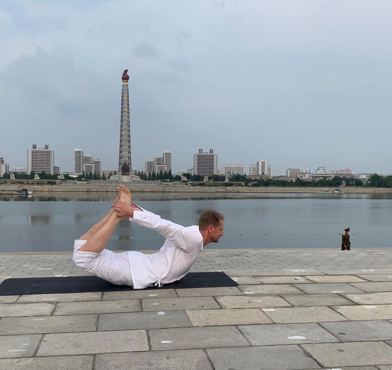 Swedish Ambassador Joachim Bergstrom practices yoga next to the Taedong River in Pyongyang