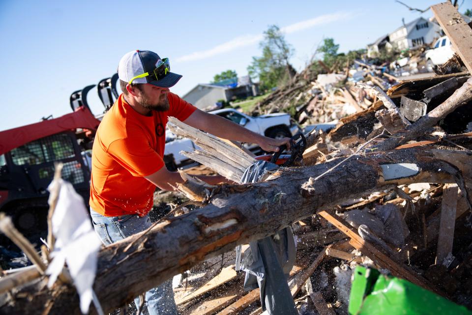 Volunteers with Graphite Construction work to clear debris on Thursday, May 23, 2024, in Greenfield, IA.