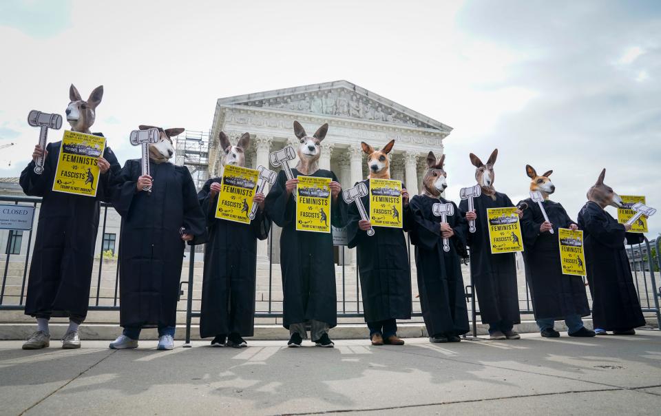 Protestors gather outside of the Supreme Court on Thursday as the justices hear arguments on whether former President Donald Trump is immune from criminal charges.