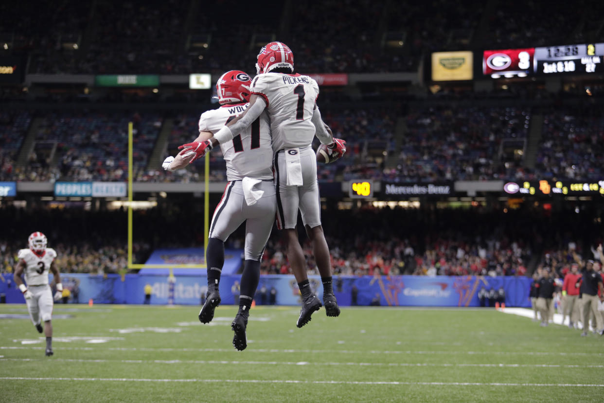 Georgia wide receiver George Pickens celebrates with teammate Eli Wolf. Pickens had 12 catches against Baylor. (AP Photo/Brett Duke)