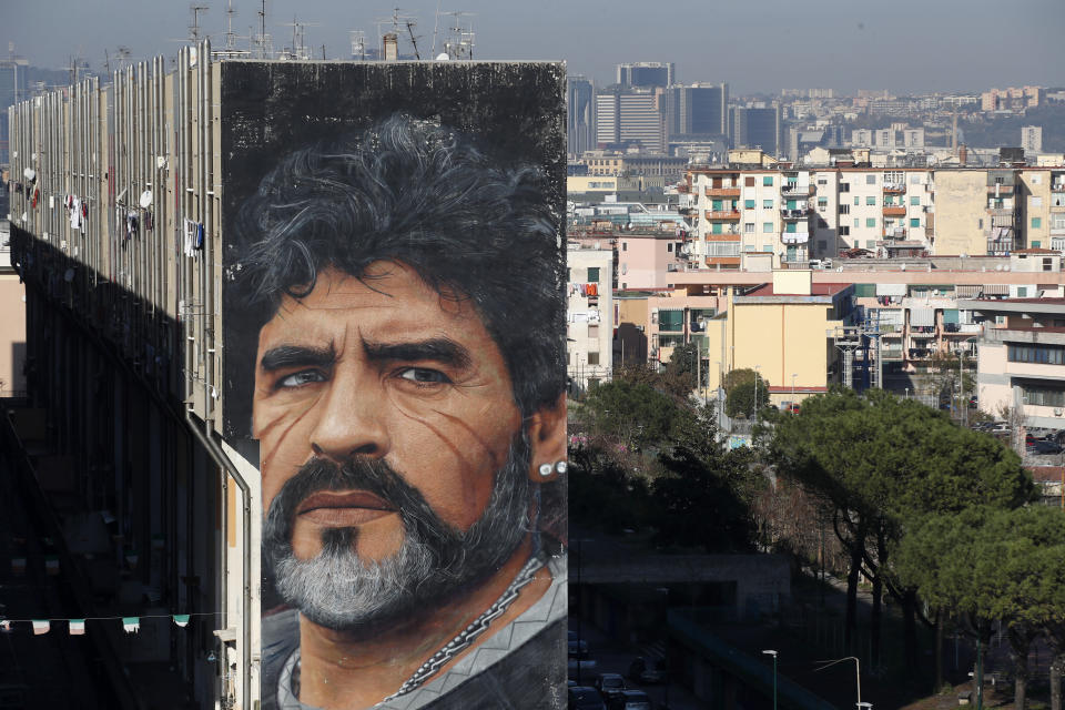 FILE - A giant mural of soccer legend Diego Maradona is displayed on a building with the backdrop of the city of Naples, southern Italy, Nov. 26, 2020, a day after his death. The legend of Diego Maradona at Napoli hovers over the current team’s Italian league title, which was sealed Thursday, May 4, 2023. The Argentina standout holds saint-like status in Naples 2 ½ years after his death and more than three decades after he led Napoli to its first two Serie A titles. (AP Photo/Alessandra Tarantino, File)