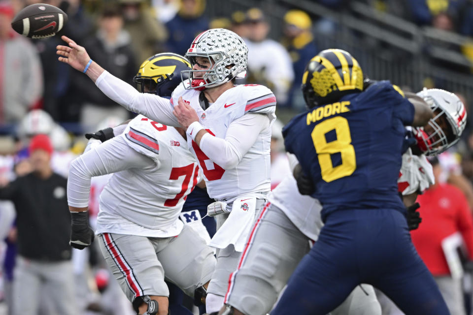Ohio State quarterback Kyle McCord throws a pass during the second half of an NCAA college football game against Michigan, Saturday, Nov. 25, 2023, in Ann Arbor, Mich. Michigan won 30-24. (AP Photo/David Dermer)
