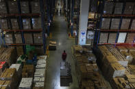 A worker pulls a trolley of goods at the Chinese online retailer JD.com's warehouse in Beijing on Tuesday, Nov. 9, 2021. China's biggest online shopping day, known as "Singles' Day" on Nov. 11, is taking on a muted tone this year as regulators crack down on the technology industry and President Xi Jinping pushes for "common prosperity." (AP Photo/Andy Wong)