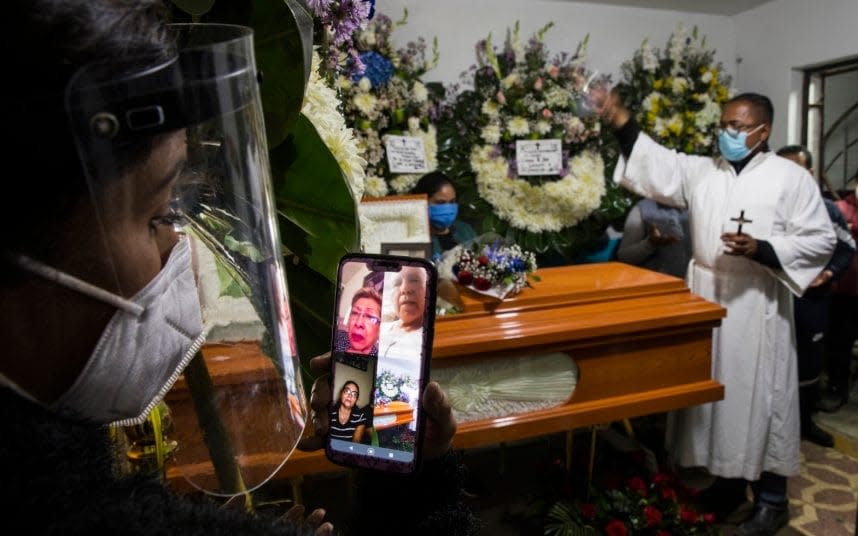 'Virtual' funerals have become the norm for many mourners - RODRIGO ABD/AP