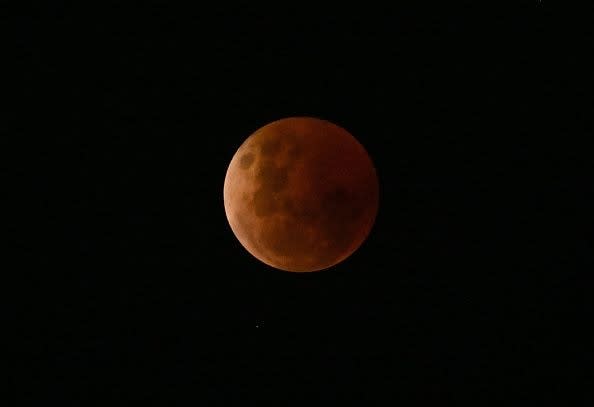 A blood moon is seen during a lunar eclipse on November 8, 2022, over Brisbane, Australia.