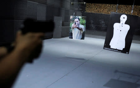 A woman fires a handgun at the 1911 Shooting Club in Sao Paulo, Brazil, January 11, 2019. Picture taken January 11, 2019. REUTERS/Nacho Doce