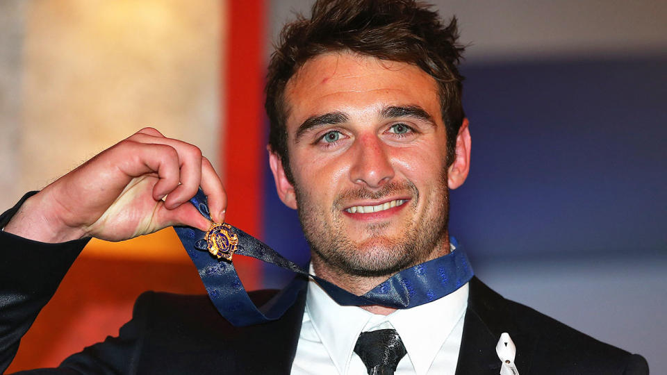 Jobe Watson, pictured here with the Brownlow Medal in 2012.