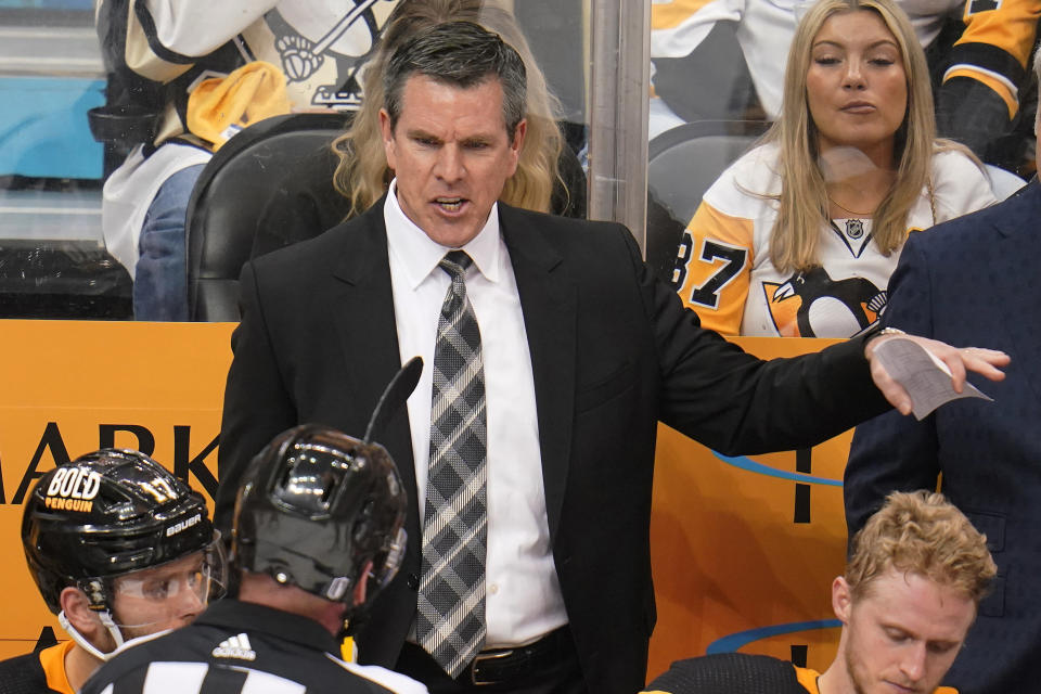 Pittsburgh Penguins coach Mike Sullivan talks with official Kevin Pollock during the third period in Game 6 of the team's NHL hockey Stanley Cup first-round playoff series against the New York Rangers in Pittsburgh, Friday, May 13, 2022. The Rangers won 5-3. (AP Photo/Gene J. Puskar)