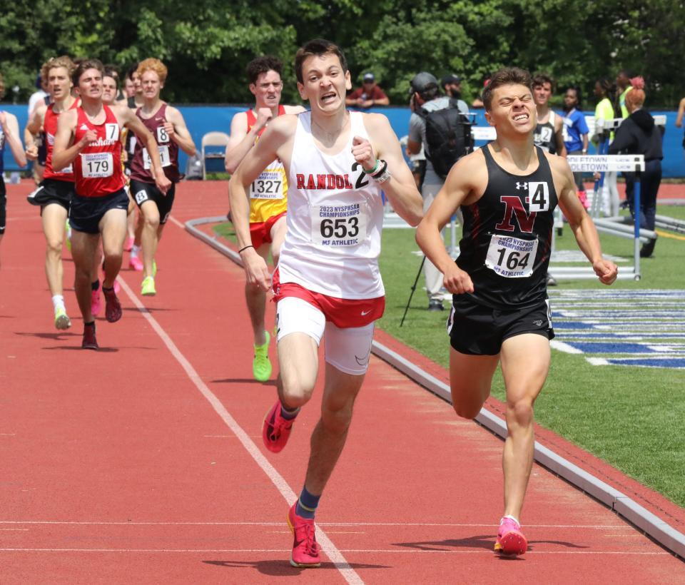 Roan Kelly from Randolph (653) and Nyack's Matthew Schutzbank (164) compete in the boys 1600 meter run championship during the New York State Track and Field Championships at Middletown High School, June 10, 2023.