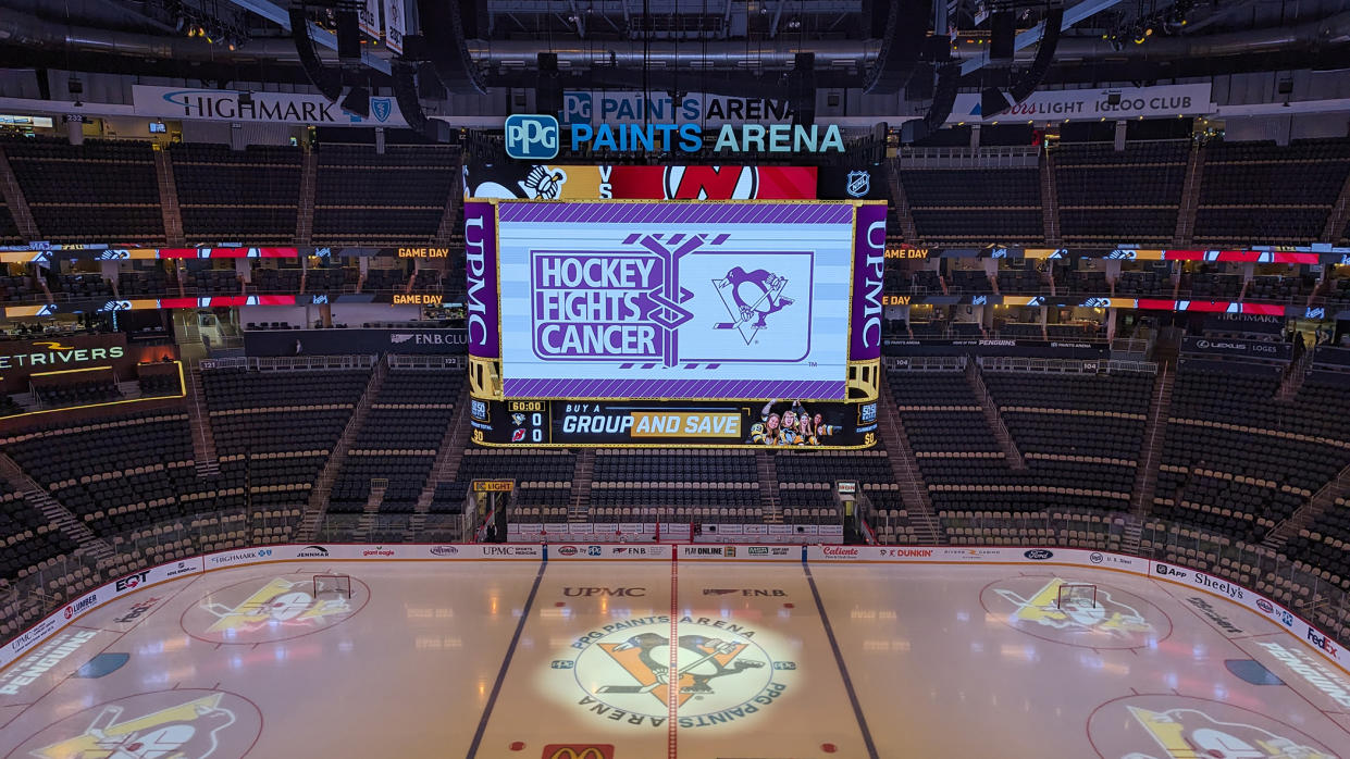  The Pittsburgh Penguins centerhang display shines bright over the ice during a game. . 