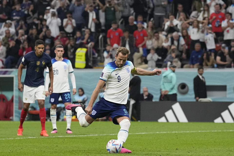 England's Harry Kane scores his side's first goal from the penalty spot during the World Cup quarterfinal soccer match between England and France, at the Al Bayt Stadium in Al Khor, Qatar, Saturday, Dec. 10, 2022. (AP Photo/Abbie Parr)