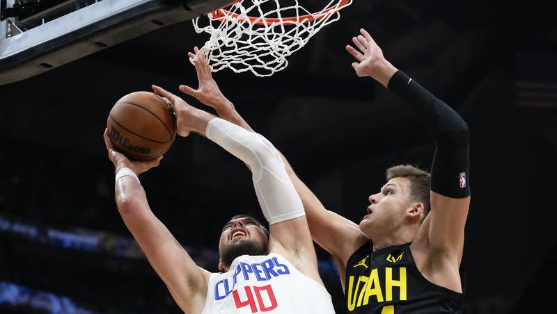 Los Angeles Clippers center Ivica Zubac (40) goes to the basket against Utah Jazz center Walker Kessler (24) during the first half of a preseason NBA basketball game Tuesday, Oct. 10, 2023, in Seattle. 