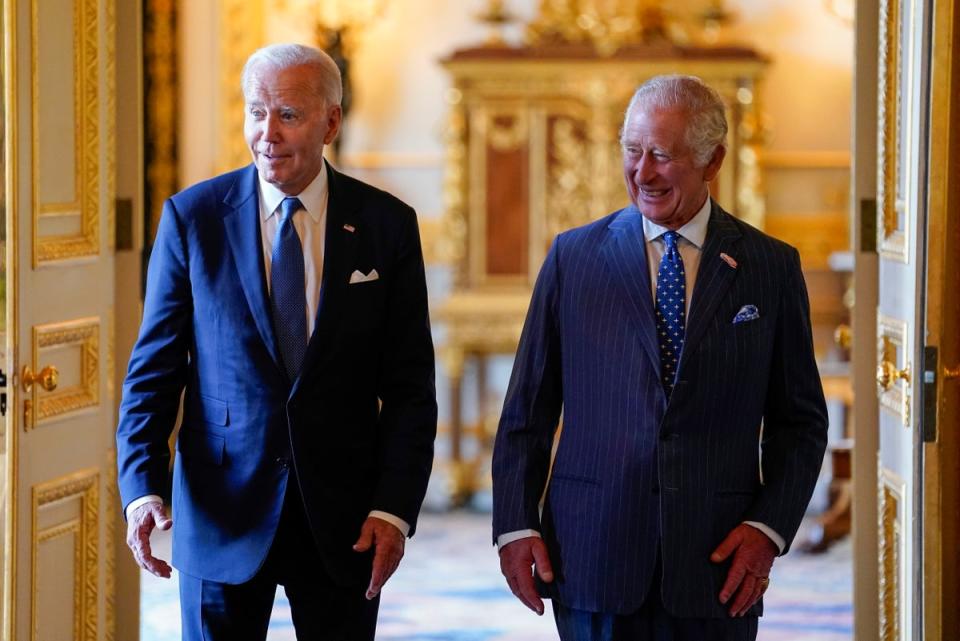 King Charles III, right, and Joe Biden arrive to meet participants of the Climate Finance Mobilisation forum in the Green Drawing Room at Windsor Castle, England, in July 2023 (AP)