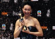 Hong Kong actress Kara Wai poses backstage after winning Best Supporting Actress for her role in the movie "Rigor Mortis" at the 33rd Hong Kong Film Awards in Hong Kong April 13, 2014. REUTERS/Bobby Yip (CHINA - Tags: ENTERTAINMENT)