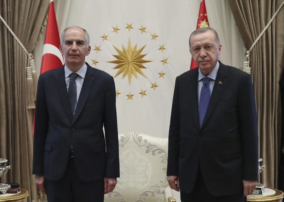 FILE - In this Aug. 19, 2020 file photo, Frence ambassador to Turkey Herve Magro, left, and Turkey's President Recep Tayyip Erdogan pose for photographs after the new ambassador presented his letter of credentials, in Ankara, Turkey. France recalled its ambassador to Turkey for consultations after Erdogan said Saturday, Oct. 24 French President Emmanuel Macron needed mental health treatment and made other comments that the French government described as unacceptably rude.(Turkish Presidency via AP, Pool)