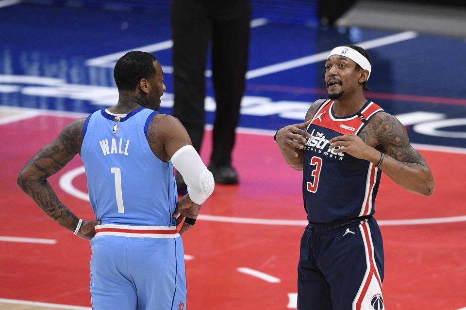 Houston Rockets guard John Wall (1) and Washington Wizards guard Bradley Beal (3) stand on the court during the first half of an NBA basketball game, Monday, Feb. 15, 2021, in Washington. (AP Photo/Nick Wass)